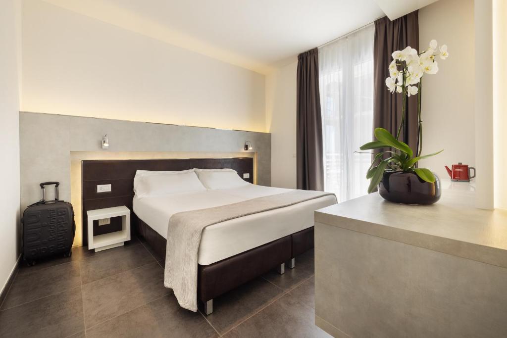 Postel nebo postele na pokoji v ubytování Baldinini Hotel