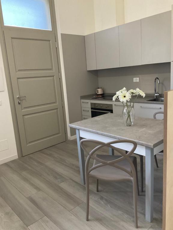 a kitchen with a table and a vase of flowers at BOITO36 in Campi Bisenzio