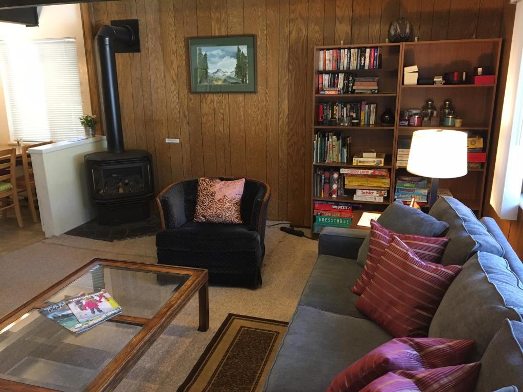 a living room with a couch and a fire place at Classic Carnelian Bay Log Cabin in Carnelian Bay