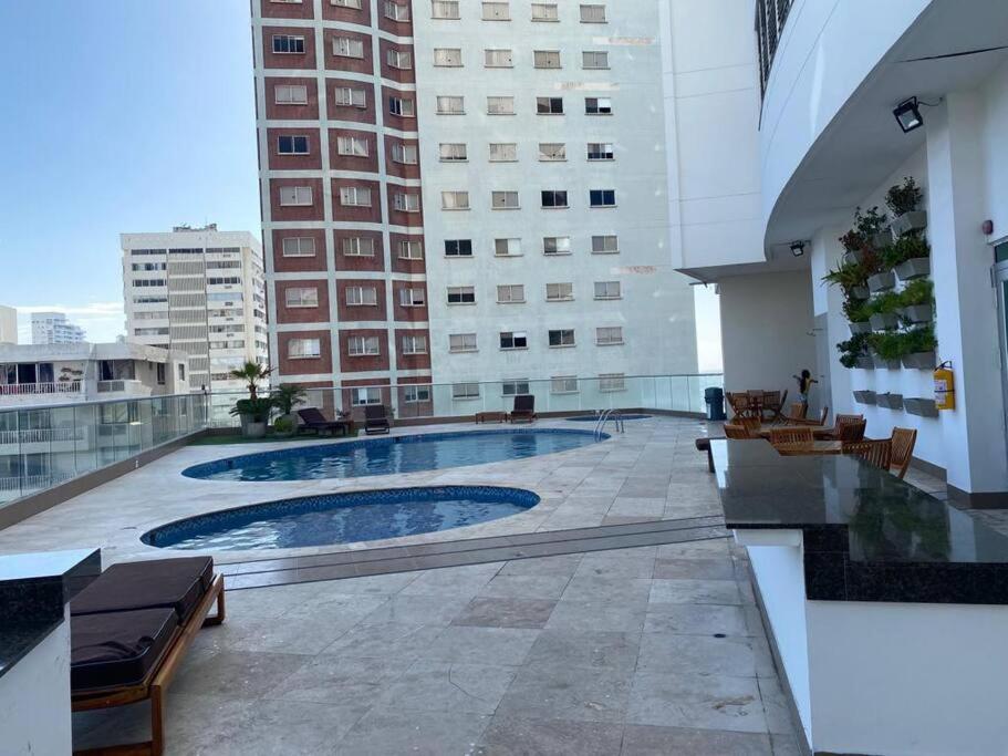 a swimming pool on the roof of a building at Apartamento frente a la playa in Cartagena de Indias