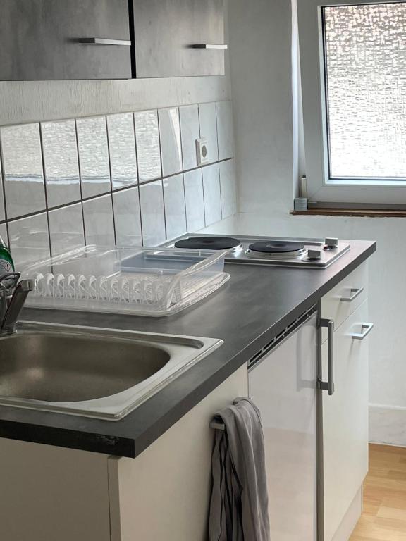 a kitchen with a sink and a counter top at Unterkunft in Springe Zentrum in Springe