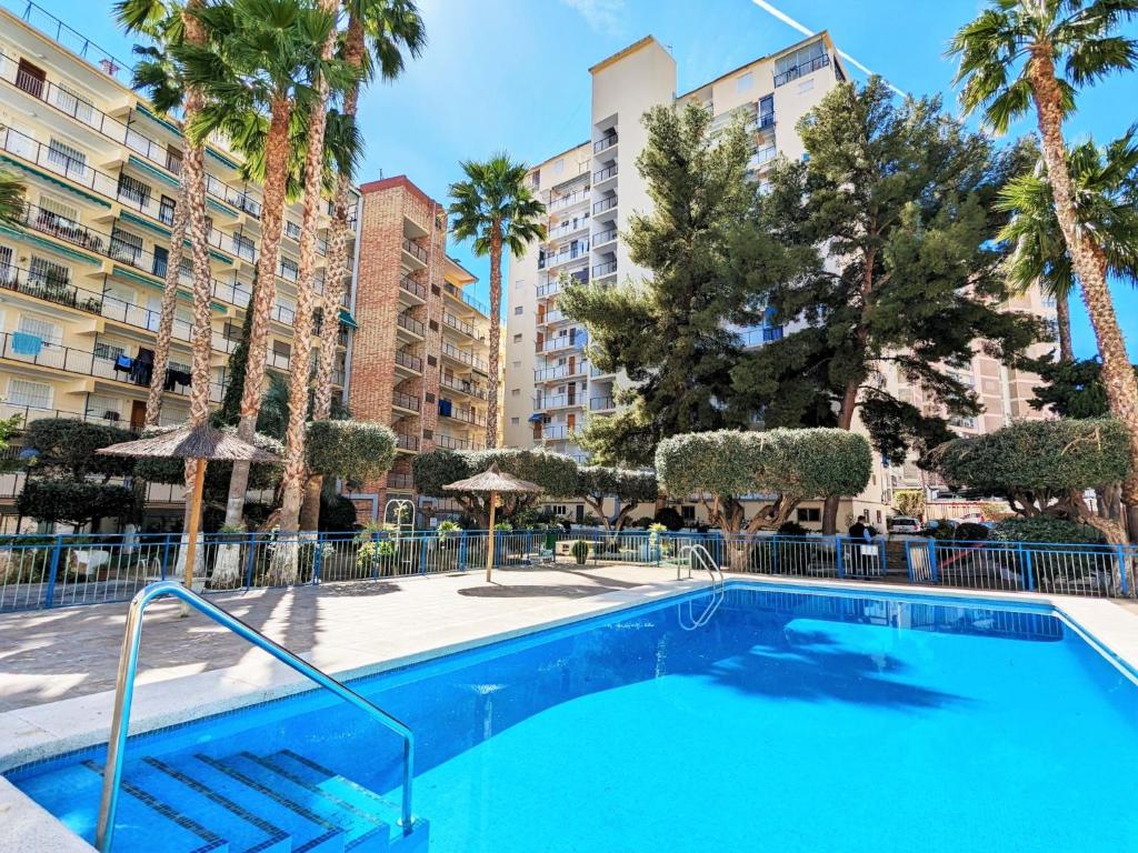 een zwembad met palmbomen en gebouwen bij Apartment Dona I by Interhome in Benidorm