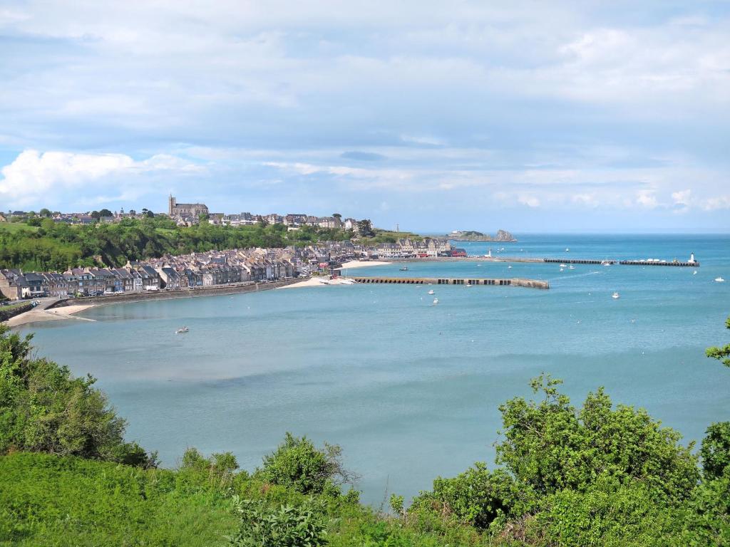 a view of a beach with a pier in the water at Holiday Home La Vallée by Interhome in Cancale