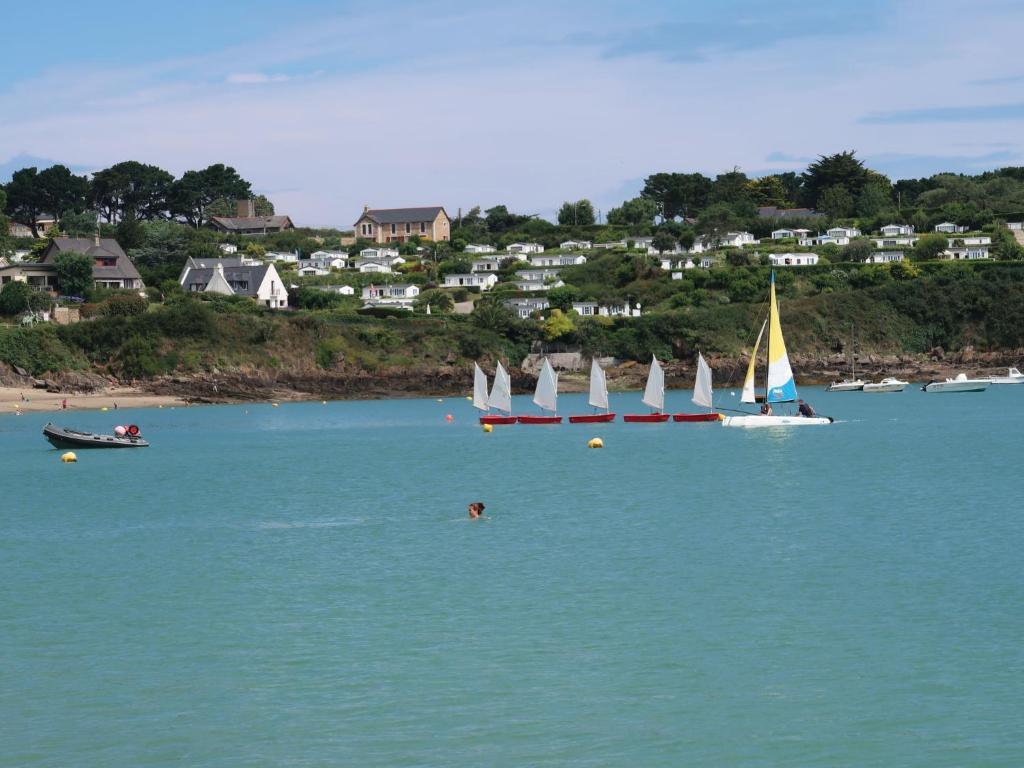 a group of sailboats in the water on a beach at Holiday Home La Vallée by Interhome in Cancale