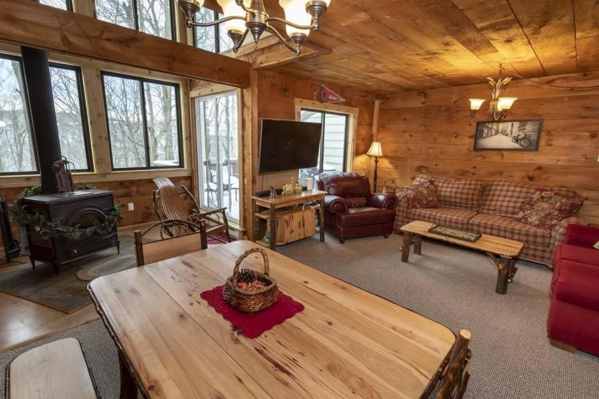 a living room with a table and a stove at Seven Springs - Swiss Mountain 3 Bedroom Standard Condo, Near Golf Course condo in Champion