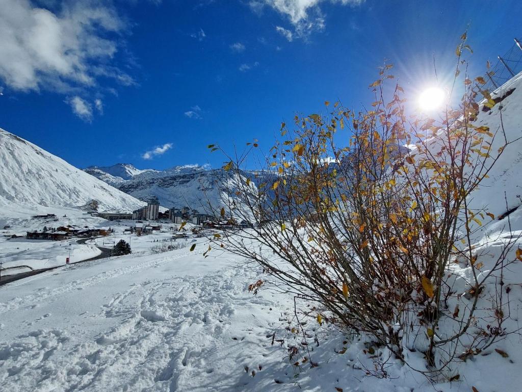 a snow covered mountain with the sun in the sky at Studio Rond Point des Pistes-19 by Interhome in Tignes