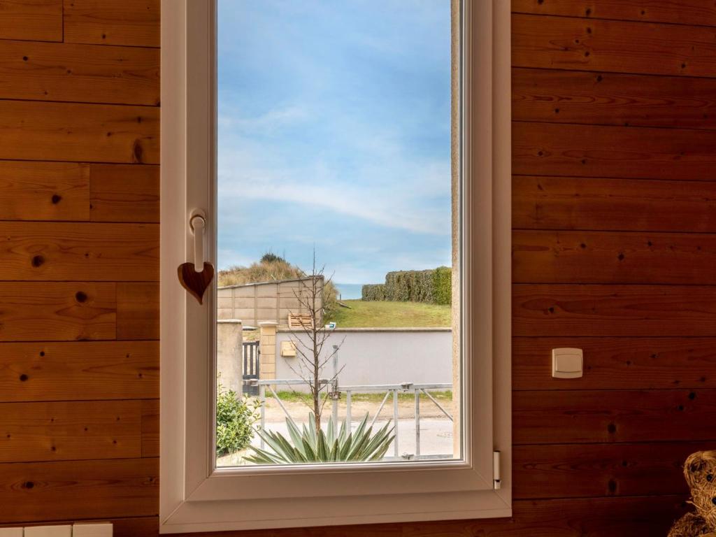 a window with a view of a building at Holiday Home La Plage by Interhome in Denneville