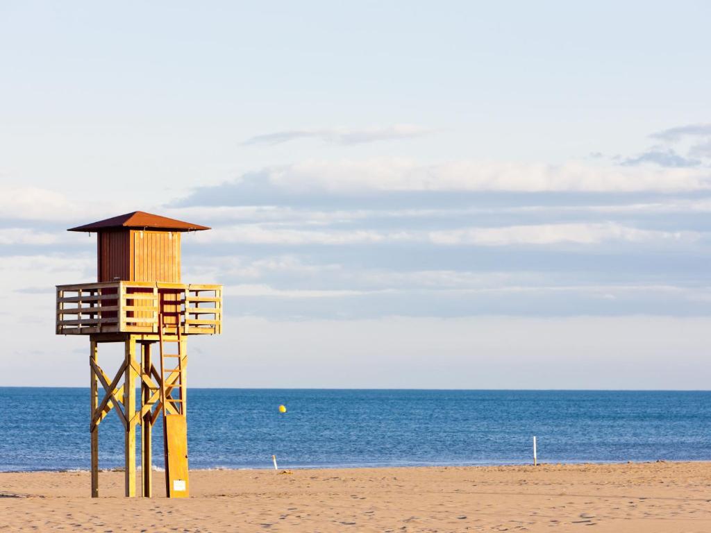 a life guard tower on a beach near the ocean at Apartment Eden Roc 2 by Interhome in Narbonne-Plage
