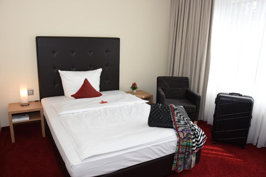 Postel nebo postele na pokoji v ubytování Concorde Hotel Viktoria