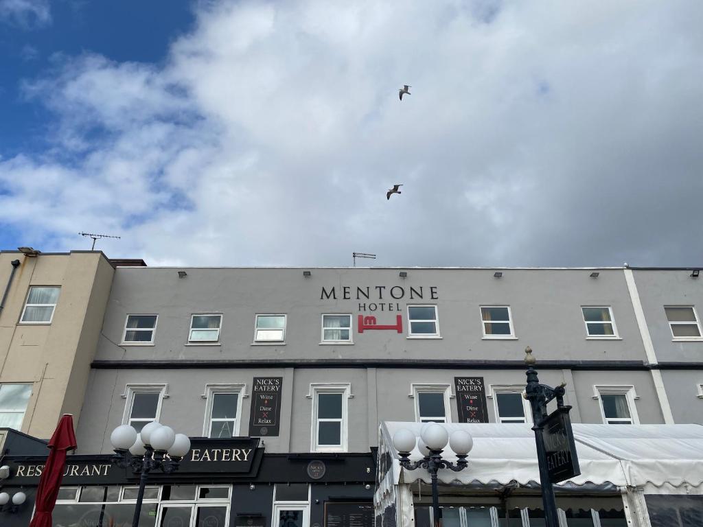 a building with a sign that says mentone not at Bay view rooms at Mentone Hotel in Weston-super-Mare