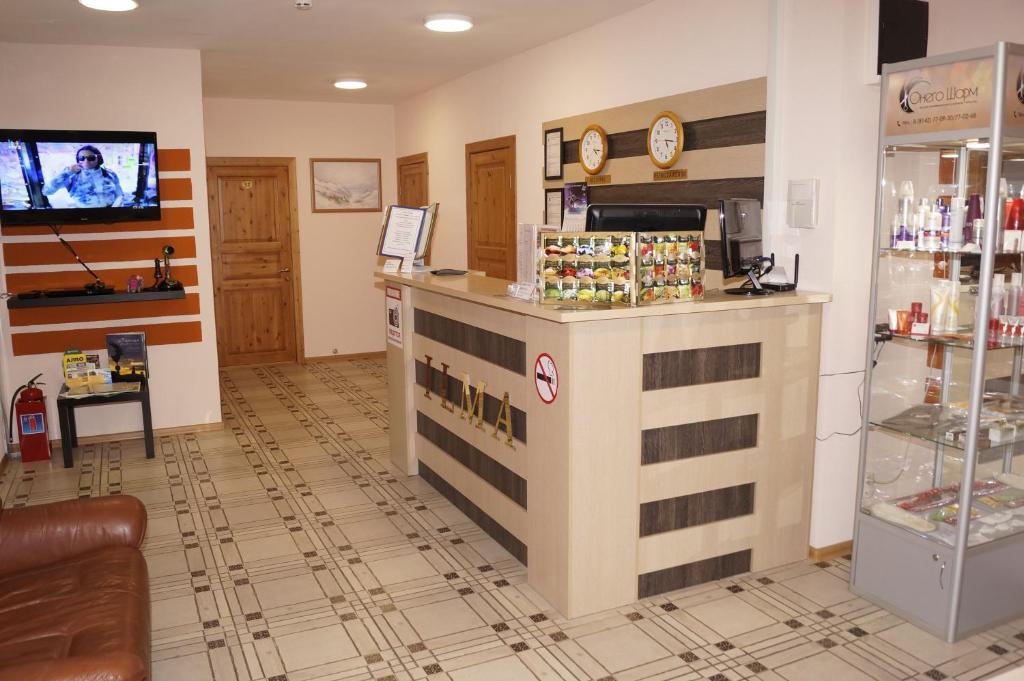 a store lobby with a counter and a tv at Mini-Hotel Ilma in Petrozavodsk