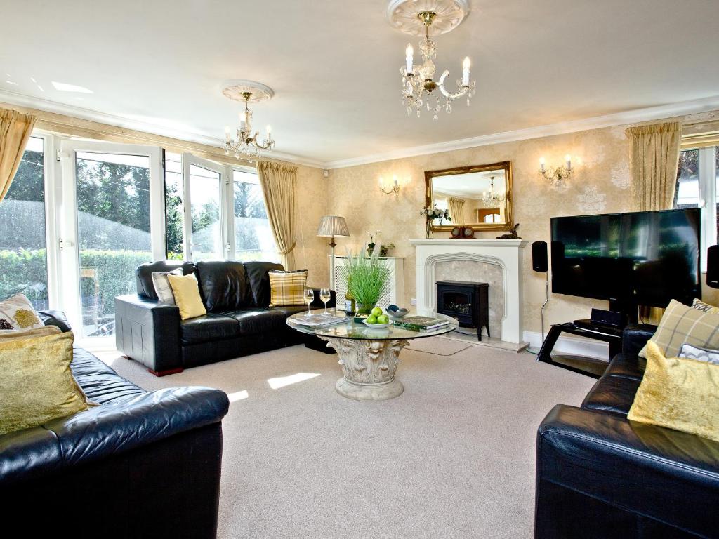 uma sala de estar com sofás e uma televisão em Bishopsgate em Torquay