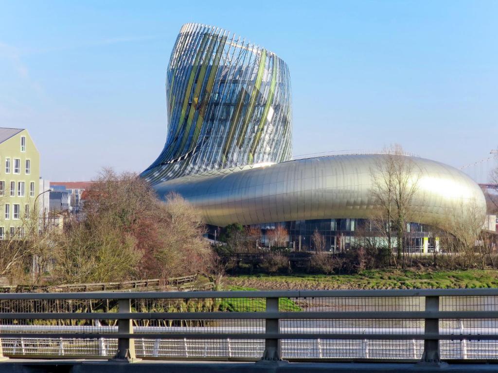 a building with a curved roof and a bridge at Holiday Home Les maisons de la forêt by Interhome in Lacanau-Océan