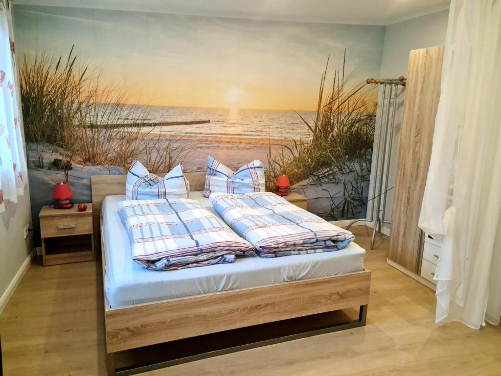 a bedroom with a bed with a painting of the ocean at Ferienappartement Ückeritz Usedom in Ueckeritz