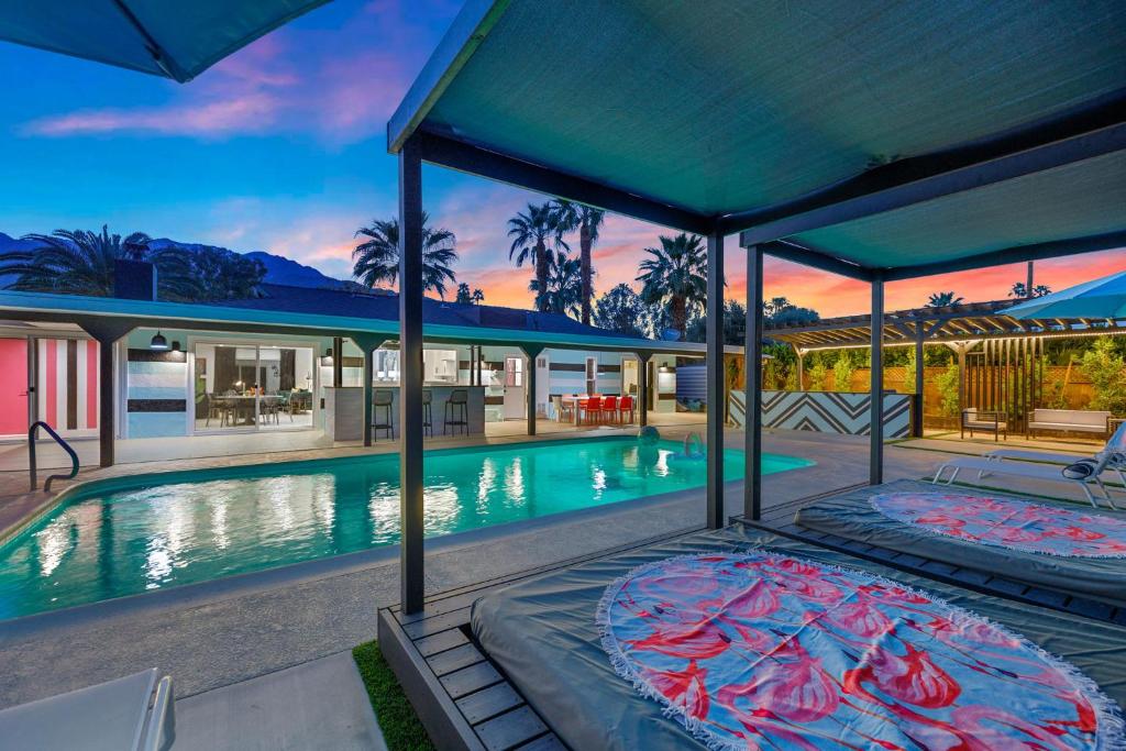 an estate with a swimming pool and a house at The Ritz - Luxury Home with Pool & Speakeasy Bar in Palm Springs