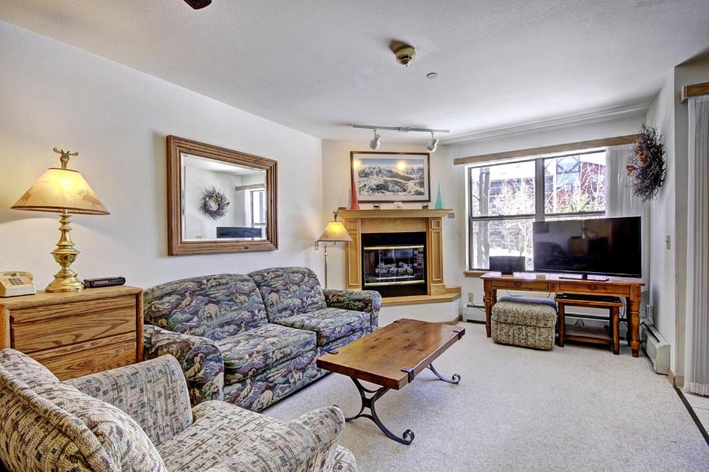 a living room with a couch and a table at River Mtn Lodge W110C in Breckenridge