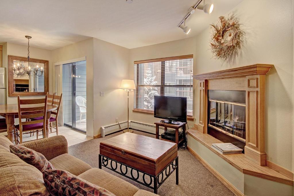 a living room with a couch and a fireplace at River Mtn Lodge E215D in Breckenridge