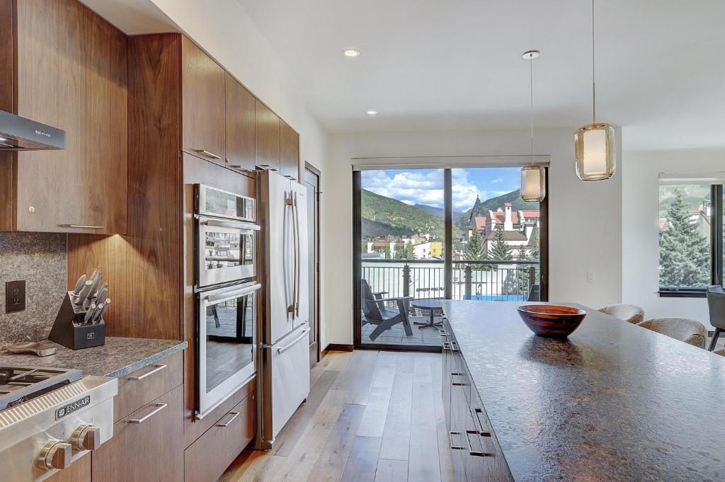 a kitchen with a counter top with a large window at The Lion Vail- 4 Br Modern Mountain Luxury- 2966 Sq Ft Condo in Vail