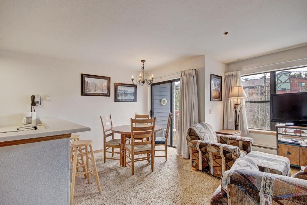a kitchen and living room with a table and chairs at River Mtn Lodge W219 in Breckenridge