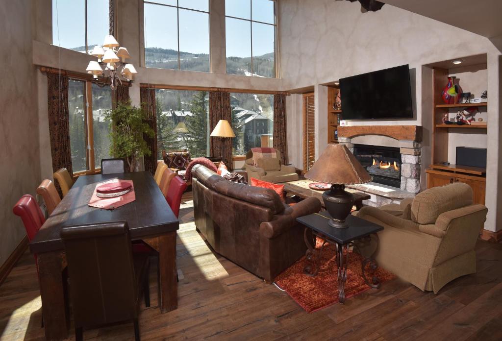 a living room with a couch and a table and a fireplace at Elkhorn 509 in Avon