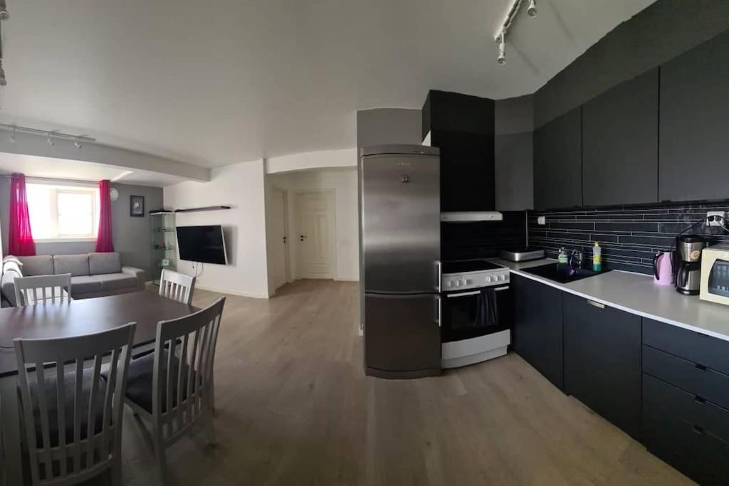 a kitchen and living room with a table and a stove at Beautiful apartment in Tromsø in Tromsø