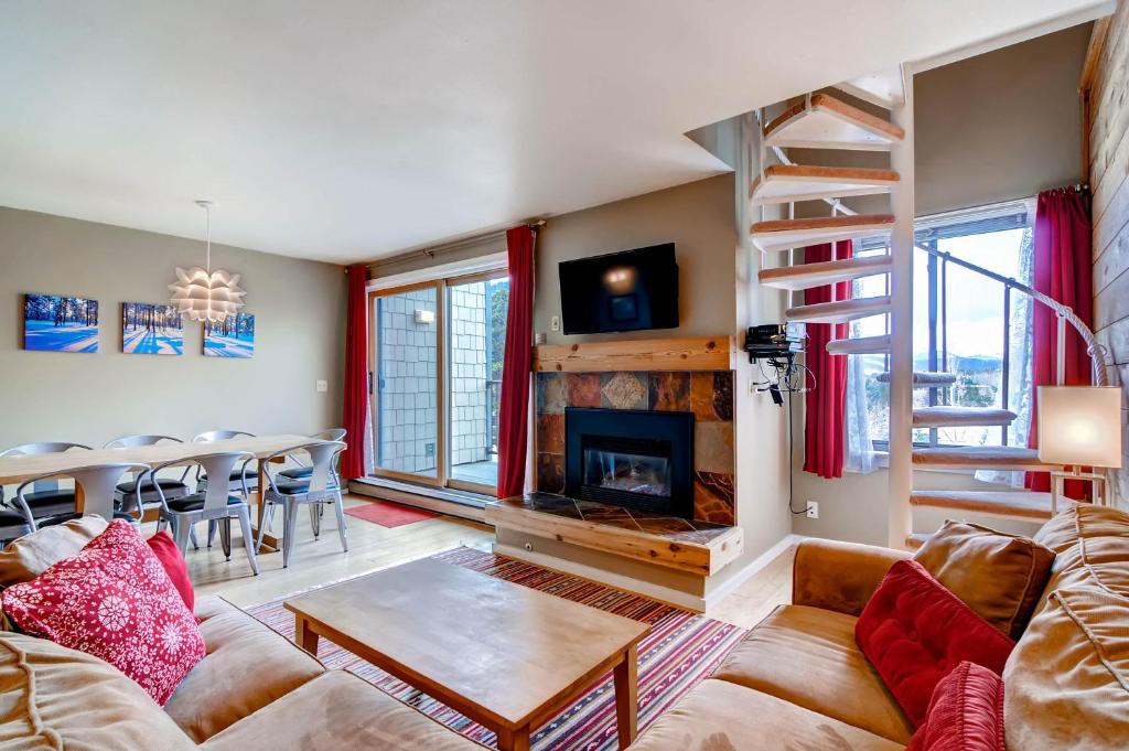a living room with a couch and a fireplace at Plaza 1407 in Keystone