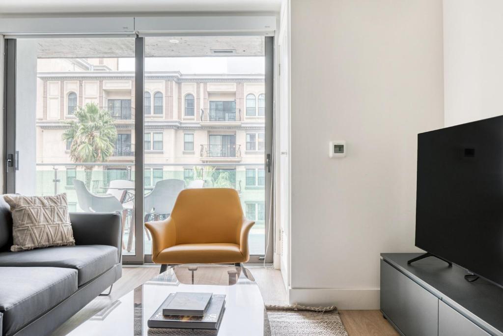 a living room with a couch and a chair at Downtown 1BR w Pool Gym WD nr Staples Center LAX-547 in Los Angeles