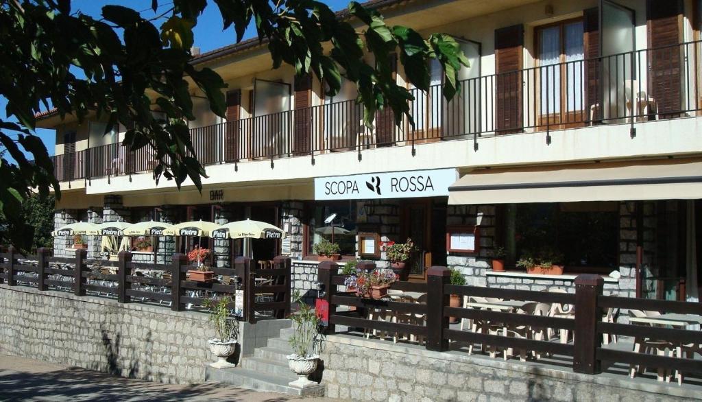 a building with a sign for a flower shop at Scopa Rossa in Evisa