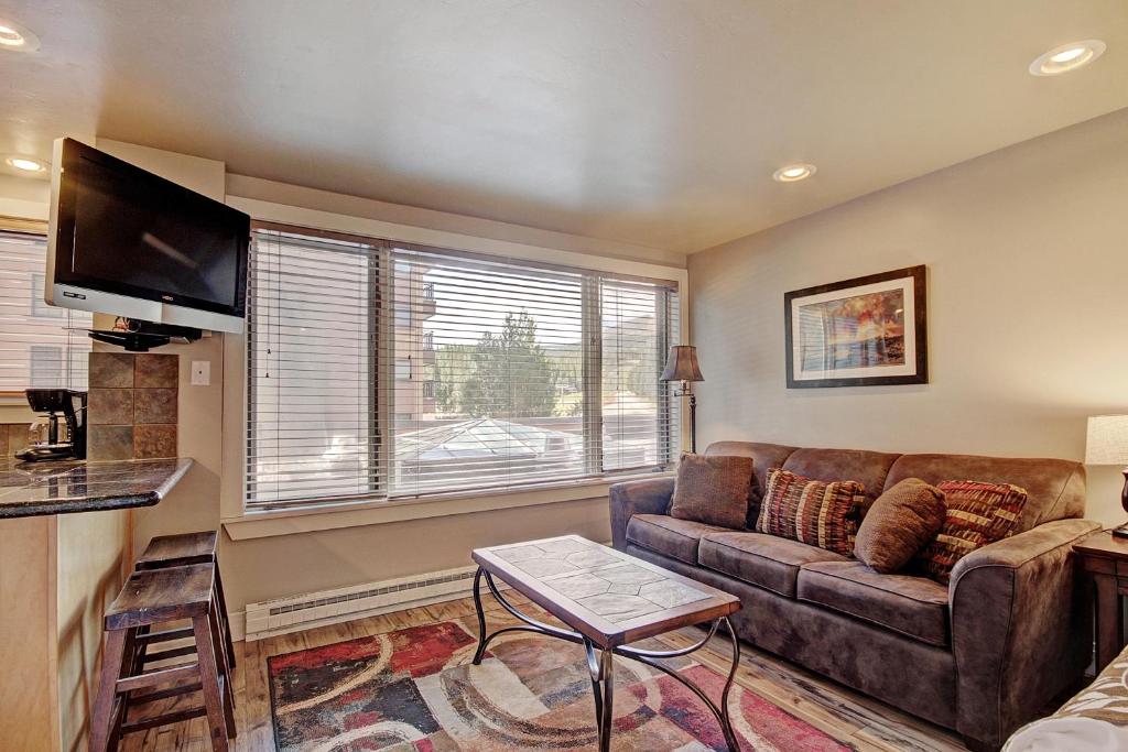 a living room with a couch and a large window at Village at Breck V4309 in Breckenridge