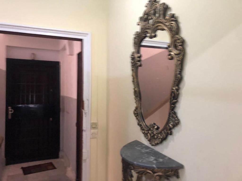 a mirror hanging on a wall next to a door at Studio à centre ville boulevard pasteur in Tangier