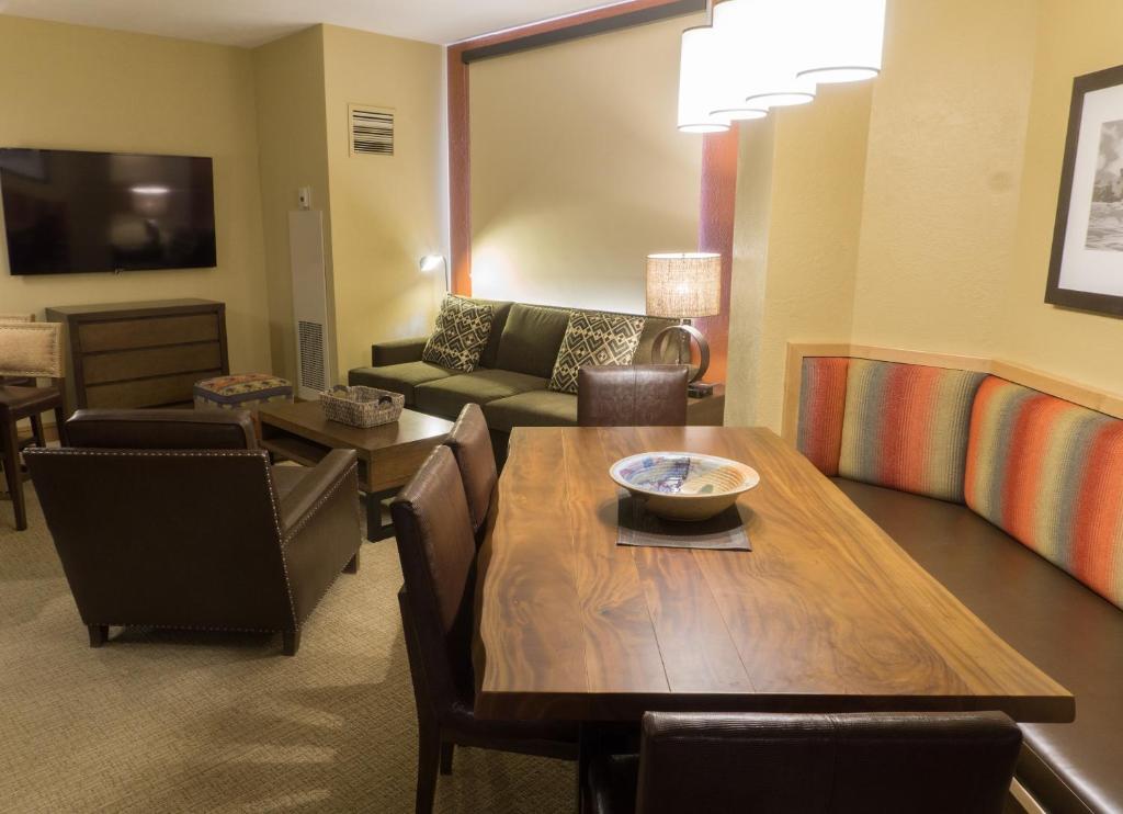 a living room with a table and a couch at Grand Summit G468 in Park City