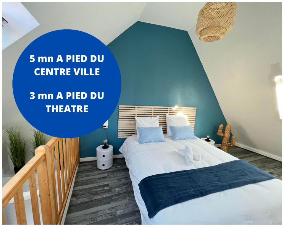 a bedroom with a bed with a blue wall at Cosy Casa in Abbeville