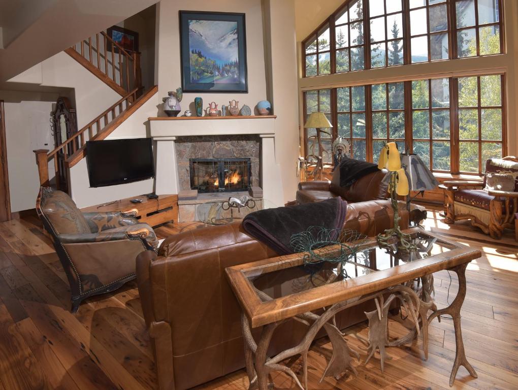 a living room with leather furniture and a fireplace at The Pines 401 in Beaver Creek