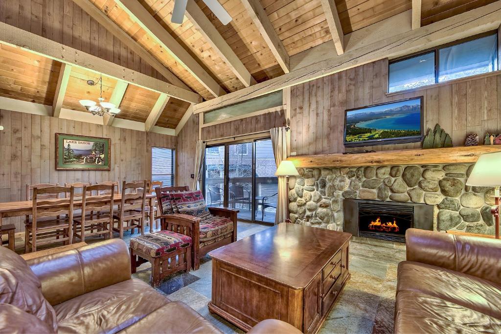 a living room with a fireplace and leather furniture at 511 Pine Grove in South Lake Tahoe