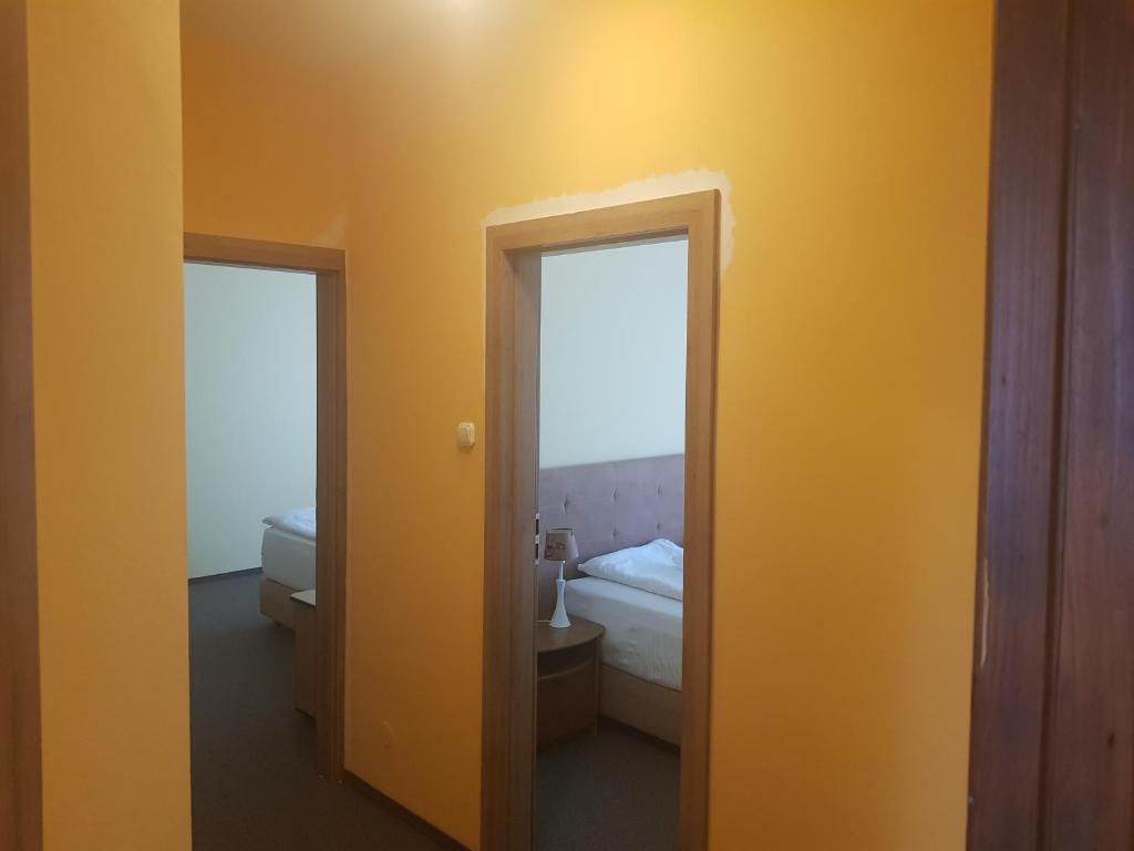 a room with a mirror and a bedroom with a bed at Vila Predeal Holidays in Predeal