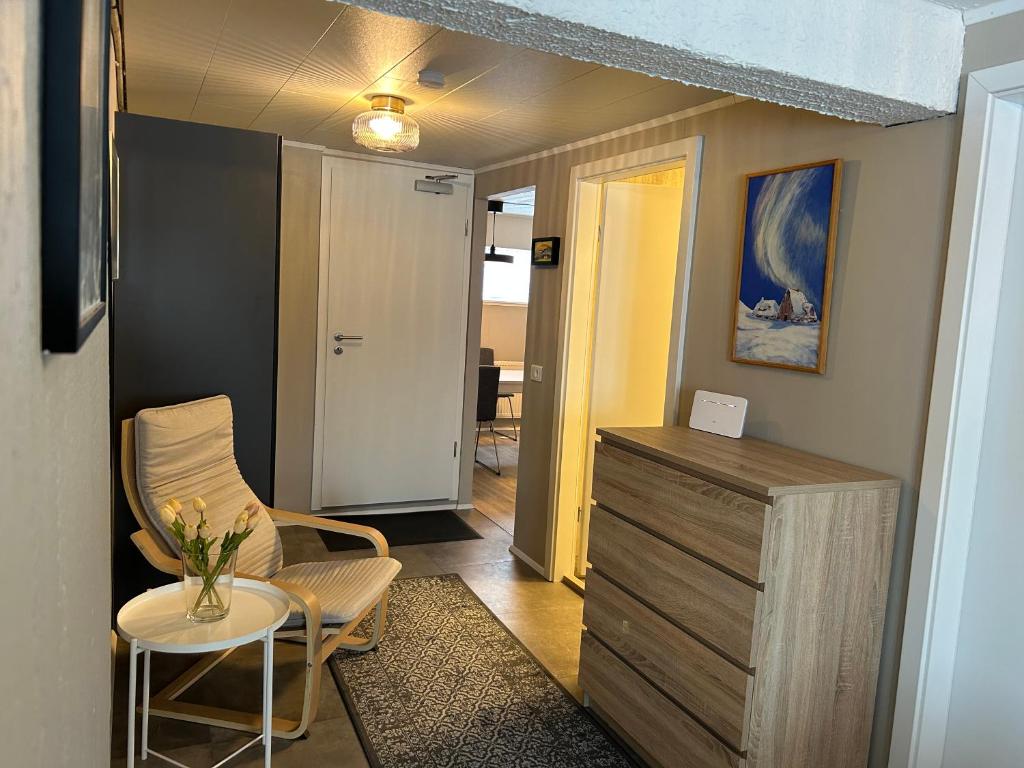 a living room with a table and chairs and a dresser at The Painter's house in Siglufjörður