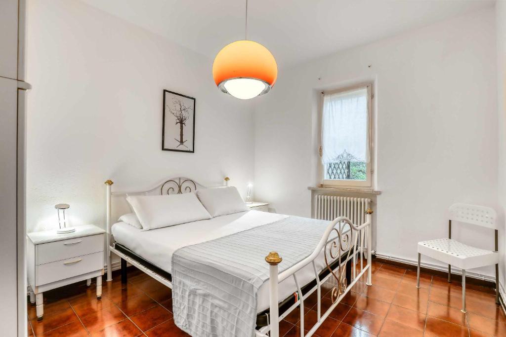 a white bedroom with a bed and a window at Ciclamini 29 - Casa Casoni in Numana