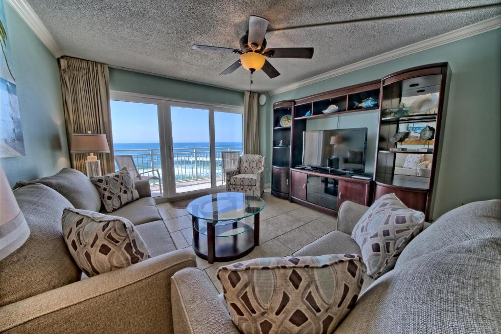 a living room with a couch and a television at Dunes of Panama in Panama City Beach
