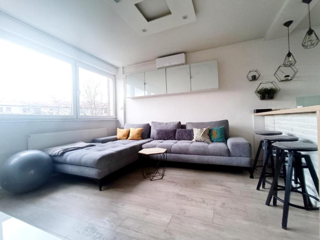 a living room with a couch and a table at Nice and Sweet Apartment - self check in in Zagreb