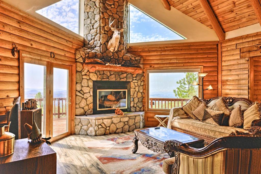 a living room with a couch and a fireplace at Mountain Bliss Chalet with Great Views! in Sonora