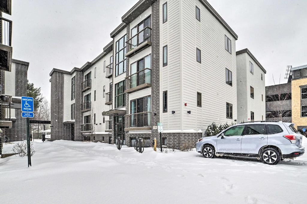 a car parked in the snow in front of a building at Traverse City Condo - Half-Mile to Front Street in Traverse City