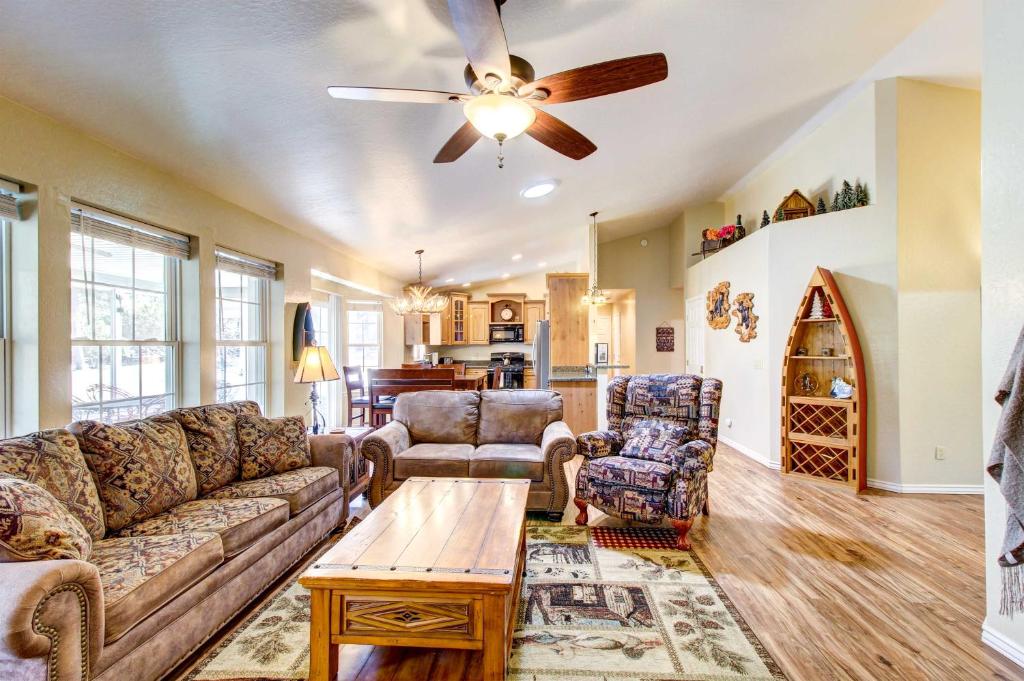 a living room with a couch and a ceiling fan at Winter Hikes and Ice Fishing Fun Cozy Show Low Home in Show Low
