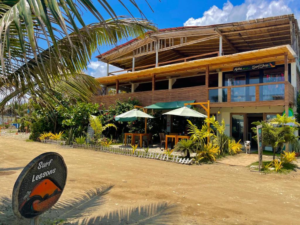 a building with a sign in front of it at El Mangle Suite Front Beach in Ayampe