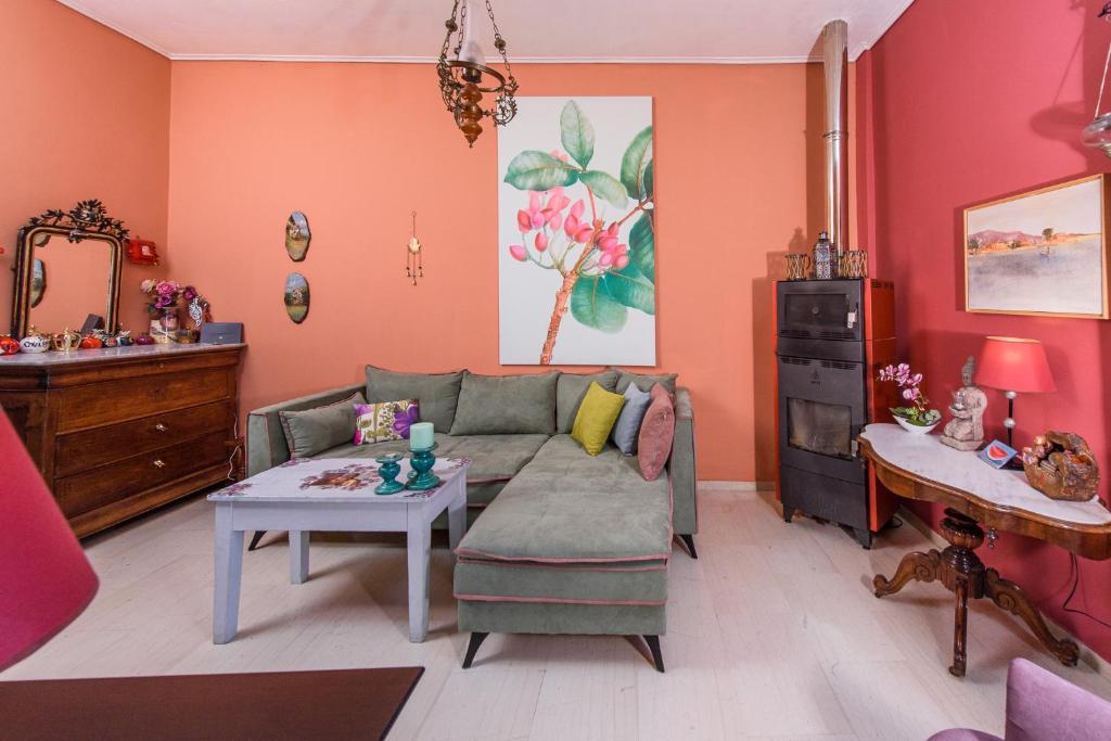 a living room with a couch and a table at Aegina's Flowers house in Aegina Town