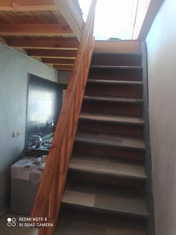 a stairway in a room with a wooden stair railing at N36 Residence Amine pour famille in Ifrane