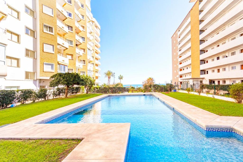 a swimming pool in front of two tall buildings at Club Maritimo at Ronda III in Fuengirola