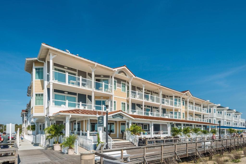 a large hotel on the beach with a pier at Bethany Beach Ocean Suites Residence Inn by Marriott in Bethany Beach