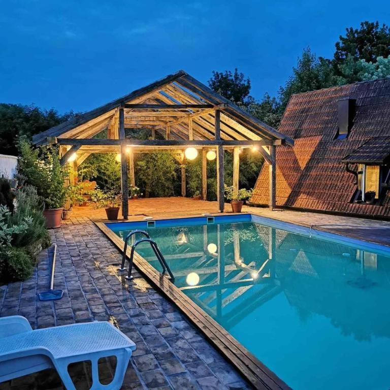 a swimming pool in front of a house at Vikendica Despotovic in Bijeljina