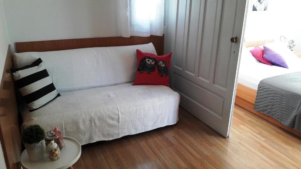 een kleine kamer met een bed met kussens erop bij Apartments Milena & Ante in Makarska
