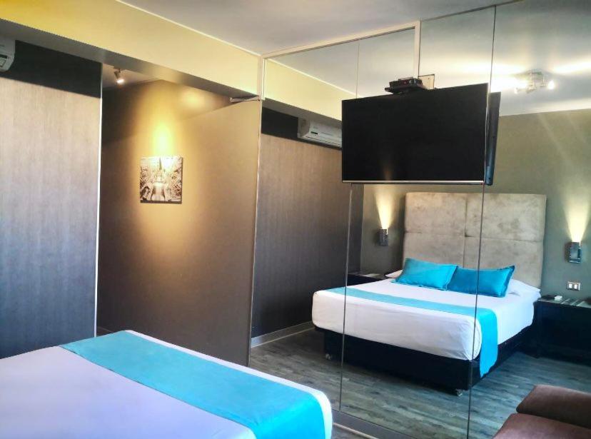 Postel nebo postele na pokoji v ubytování Hotel Las Lomas